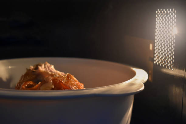 Look inside the microwave food white bowl, In a warm atmosphere and empty top space for text. Look inside the microwave food white bowl,In a warm atmosphere and empty top space for text. inside microwave stock pictures, royalty-free photos & images