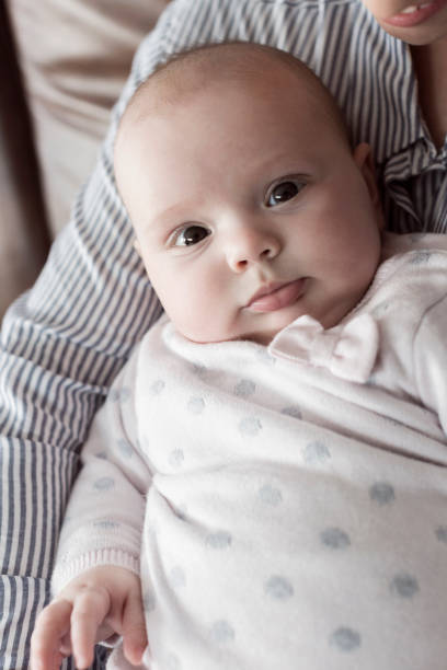 istock Mother holding daughter in lap 831360216
