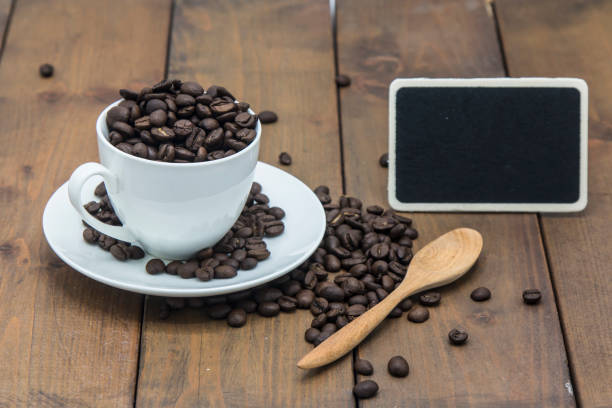 istock coffee beans in a coffee cup on a wooden floor 831360794