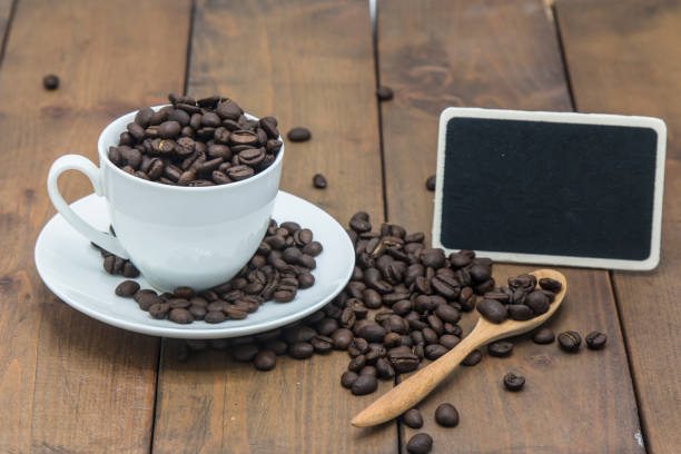 istock coffee beans in a coffee cup on a wooden floor 831362852