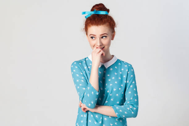 istock hy cute smile, holding hand on her lips, posing 831363062