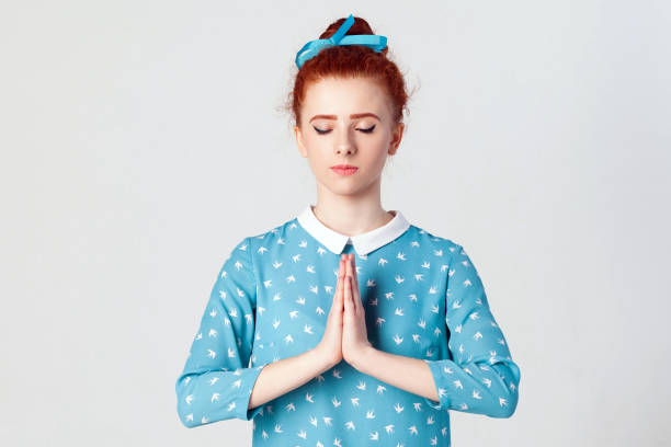 istock holding hands in namaste or prayer 831363084