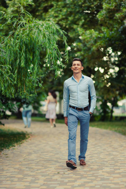 istock Handsome man on a walk in the park 831363758