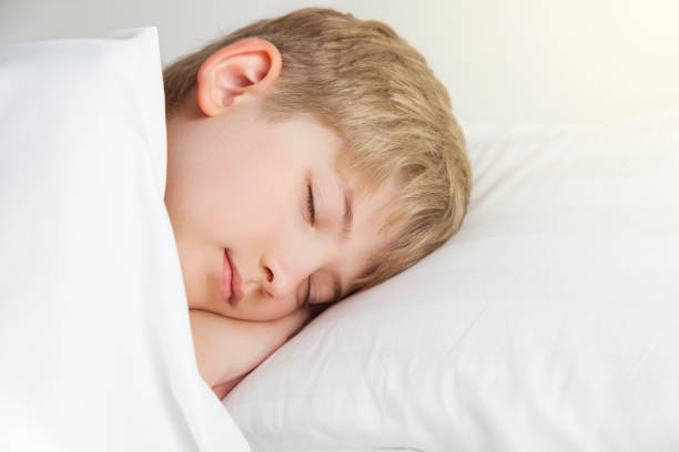 istock The boy is sleeping in a white bed 831363938