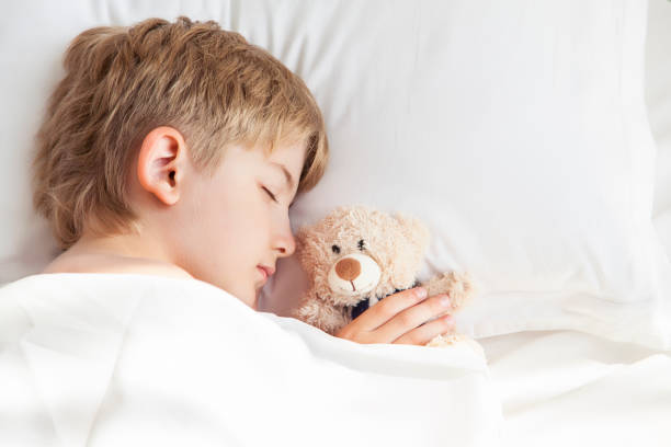 istock The boy is sleeping with a teddy bear 831363952