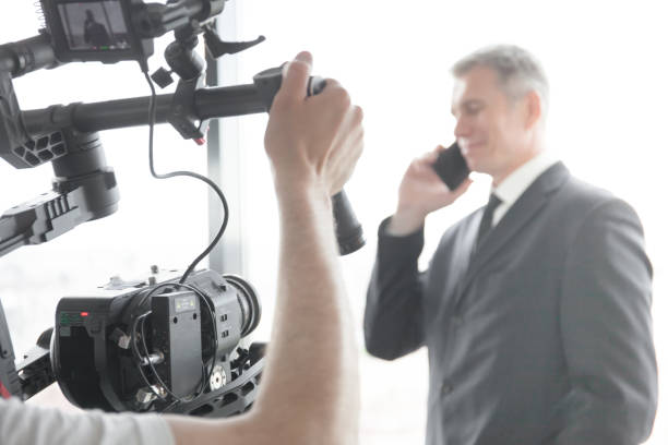 istock Videographer making video of businessman 831364706