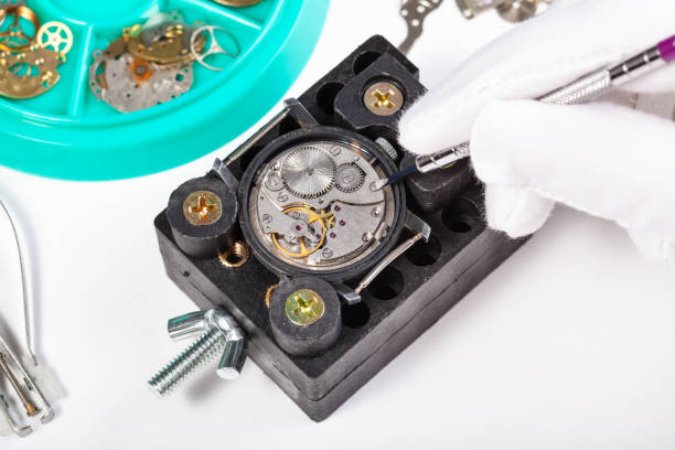 istock repairing old mechanical watch close up on table 831367134