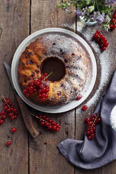 istock Bundt cake with fresh red currant. Overhead view. 831367350