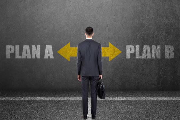 istock Businessman with plan a and plan b choice on wall 831367570