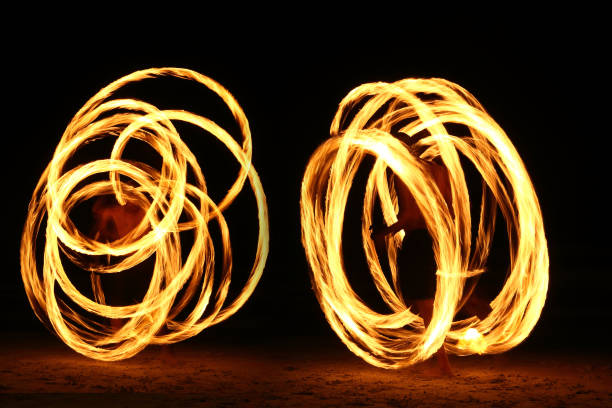 istock Skill Man playing fireworks by spinning wood pole with fuel oil and fire 831375134