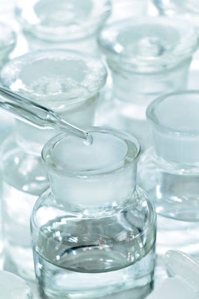 istock Dropper with chemical reagent being added to bottle on white background. 831375344