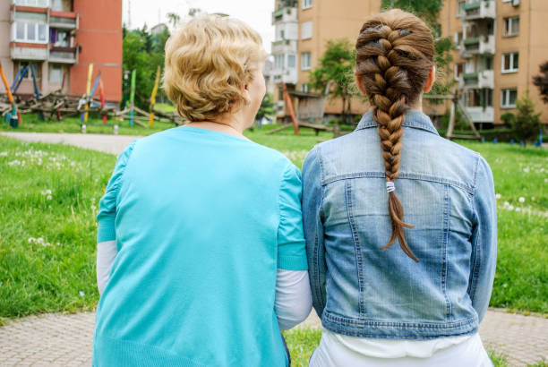 istock Two middle-aged sisters are sitting next to each other, and express loyalty, attention, love, support and understanding 831376182
