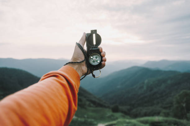 POV image with compass in mountains. stock photo