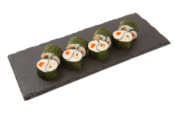 istock Roll on a black slate board - tobiko orange salmon 831381730