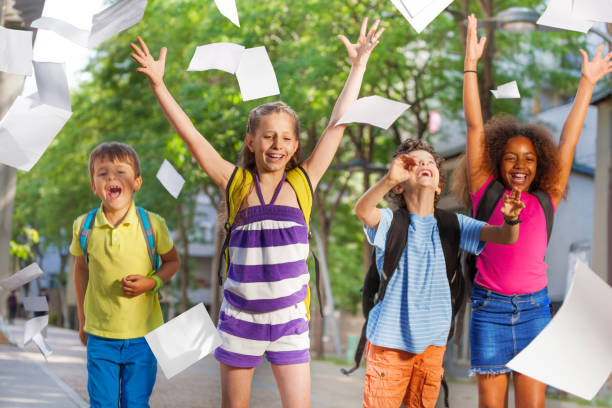 istock Cool kids throw papers in the air from excitement 831381894