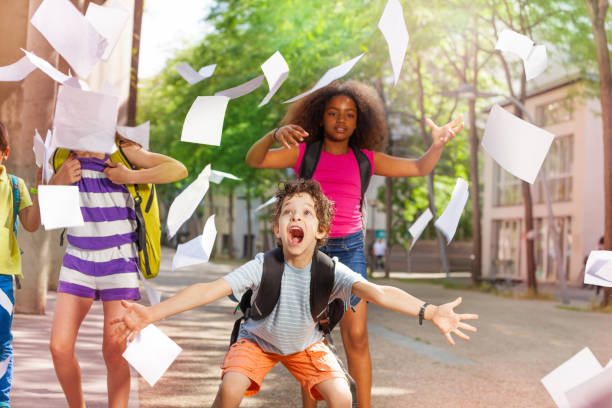 istock Very excited boy scream with friends throws paper 831382152