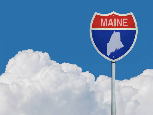 istock Highway sign for Interstate road in Maine with map in front of clouds 831382616