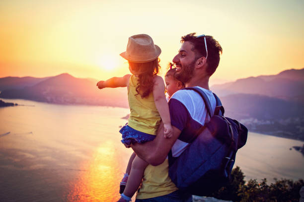 istock Father with two daughters enjoy in sunset 831387086