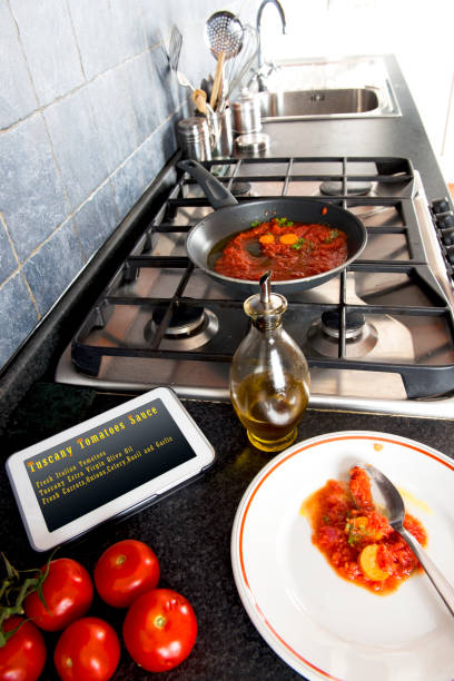 istock Tomatoes sauce cooking Recipes on Tablet 831389472