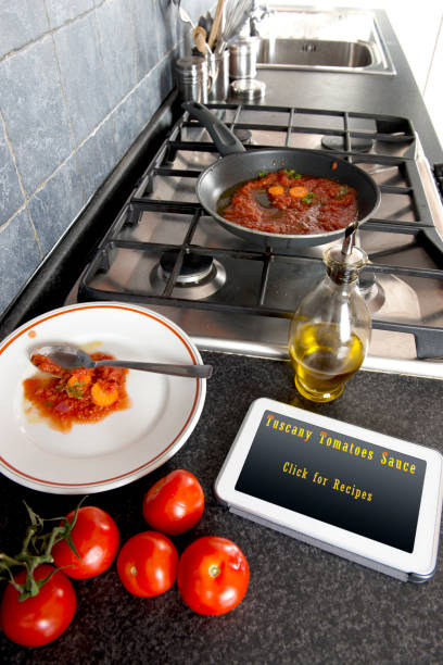 istock Tomatoes sauce cooking Recipes on Tablet 831389530