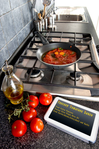 istock Tomatoes sauce cooking Recipes on Tablet 831389538