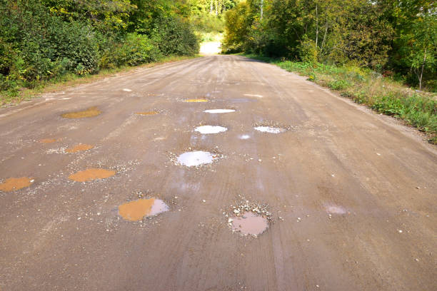 istock Potholes in a Muddy Dirt Road 831393500