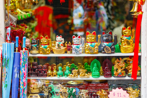 Maneki-neko (beckoning cat), Japanese figurines on display in a souvenir shop in London Chinatown