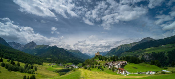 panoramic view of the village of tarasp in the swiss alps - castle engadine alps lake water imagens e fotografias de stock