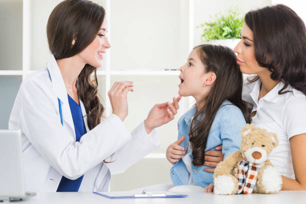 istock Doctor examine child's throat 831396920