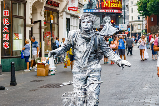 London, UK - July 22, 2017 - Street artist performing living statue in London Chinatown