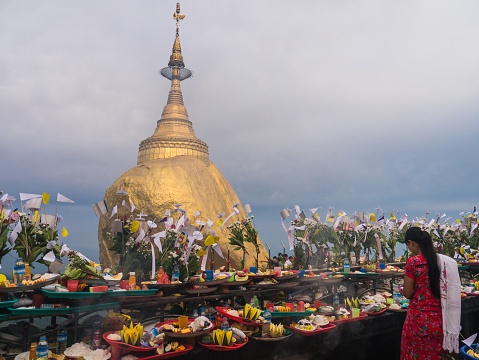 Mon State, Myanmar - April 15, 2017: Unidentified Buddhists pray at Kyaiktiyo Pagoda, Golden Rock in Mon State, Myanmar