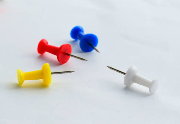 istock Pins on white paper, Focusing on red pin. 831404632