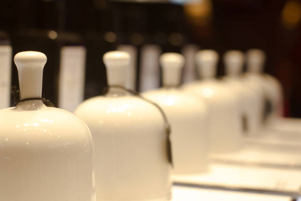 perspective view of white ceramic fragrance bells in niche perfume store selective focus
