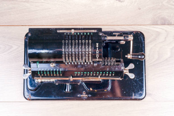 istock Old rusty retro calculator black standing on a wooden table 831407830