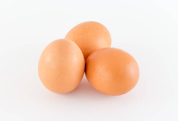 istock Group of brown raw eggs, isolated on white Background 831407842