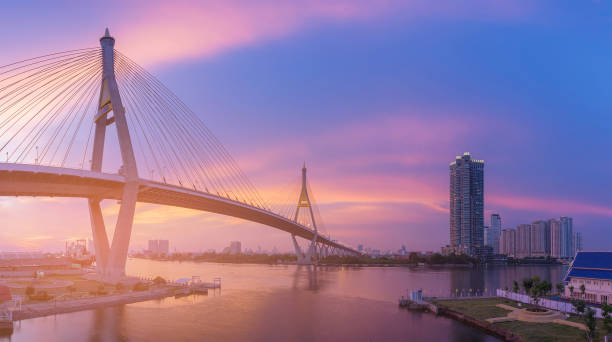 istock Twilight sky background over twin suspension bridge river front 831407920