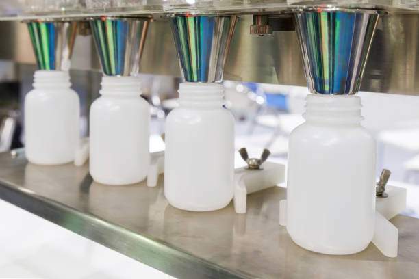 istock plastic bottle on production line of conveyor at filling machine. 831408404