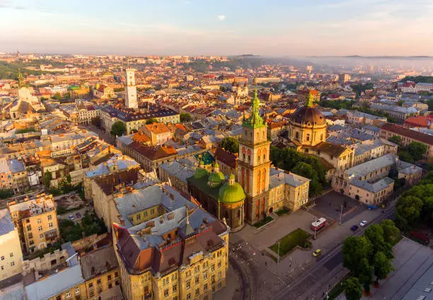 Flying over Lviv City, Ukraine. Town Hall, the tower, Dominican church. Panorama of the ancient city. The roofs of old buildings
