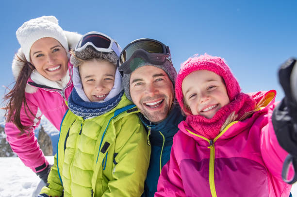 family taking winter selfie - family skiing ski vacations imagens e fotografias de stock
