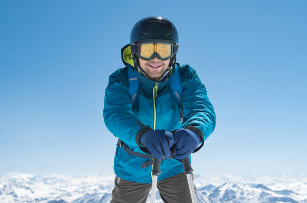 istock Skier standing holding ski poles 831415968