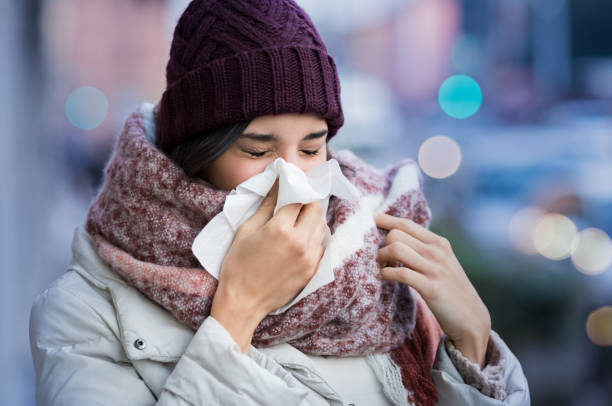 istock Woman blowing nose outdoor 831416220