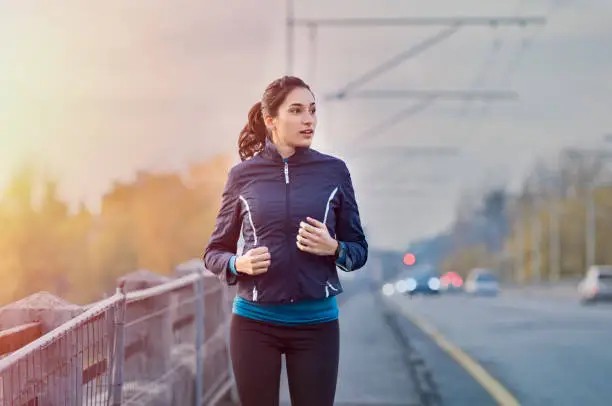 Photo of Fitness woman jogging in winter