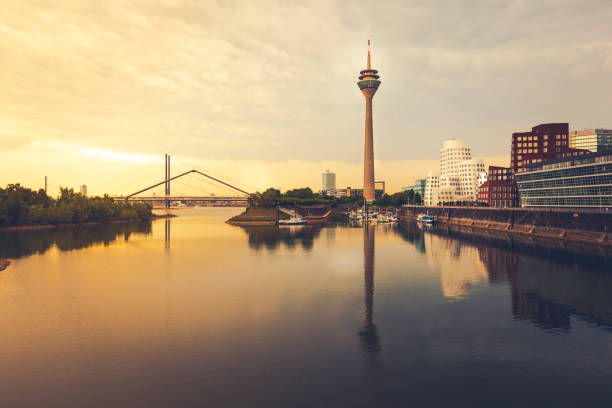 duesseldorf cityscape at sunset dusseldorf cityscape with view on media harbor at sunset, Germany. düsseldorf stock pictures, royalty-free photos & images