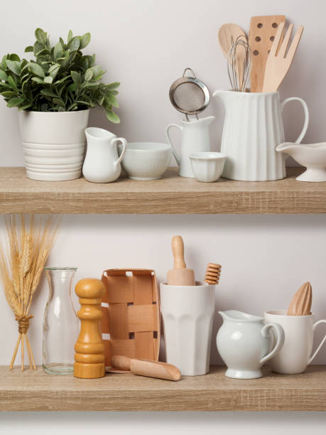 istock Kitchen utensils and dishware on wooden shelf. 831418580