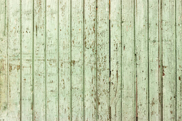 istock Bright green wooden background with peeling paint and vertical boards 831419980