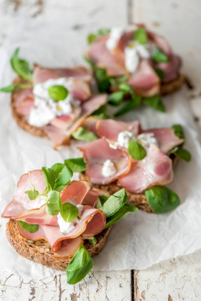 Group of open sandwiches on plate. Ready to eat.