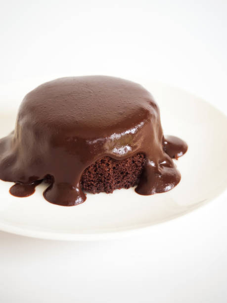 istock Chocolate cake with chocolate fudge. Served on white plate over white background. 831423022