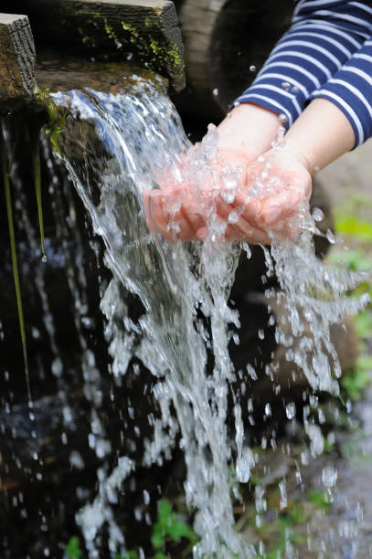 istock Water pouring in woman hand 831423266