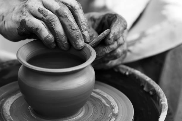 istock Potter making ceramic pot on the pottery wheel 831423284