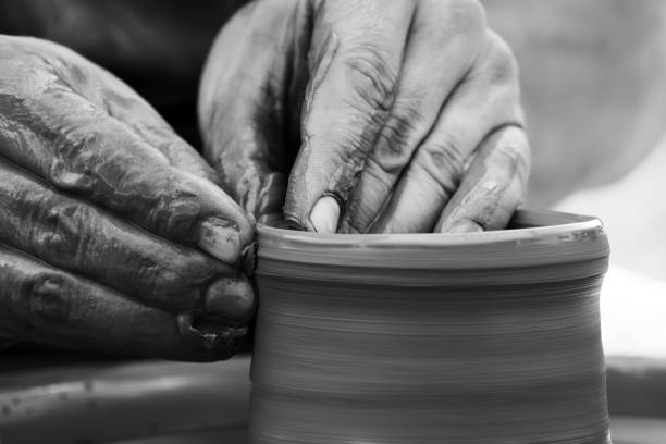 istock Potter making ceramic pot on the pottery wheel 831423308